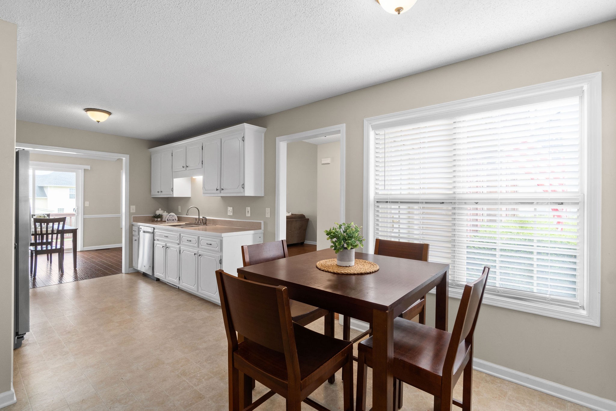 1626 Windriver Road Clarksville, TN 37042 - Photo 15 of 31 a kitchen with white cabinets a table and chairs