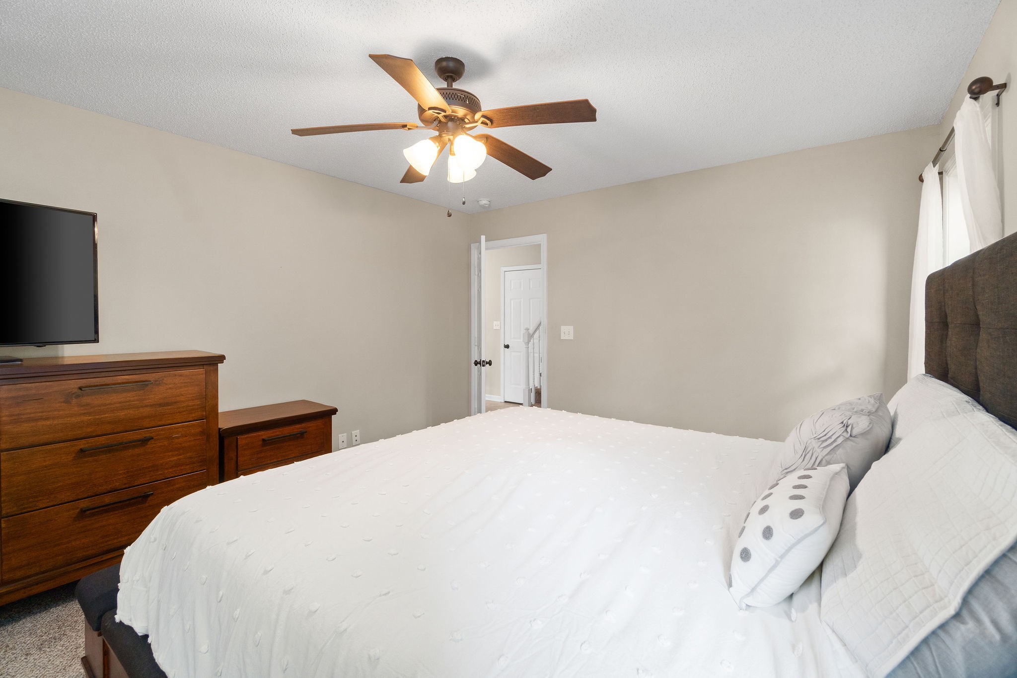 1626 Windriver Road Clarksville, TN 37042 - Photo 18 of 31 a bedroom with a bed and a flat tv screen on dresser