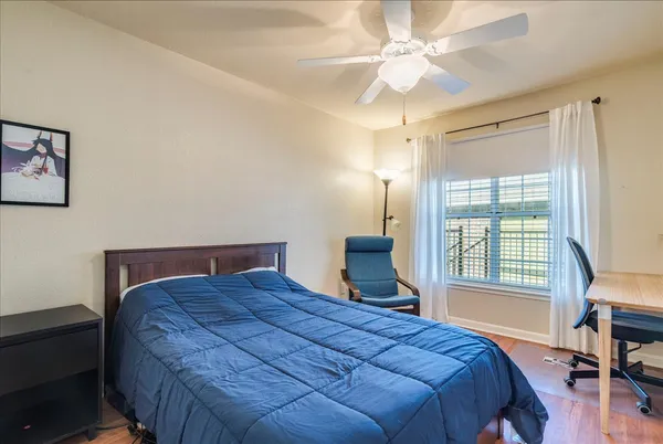 a bedroom with a large bed and a chandelier