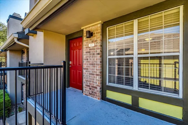 a view of front door and porch with wooden floor