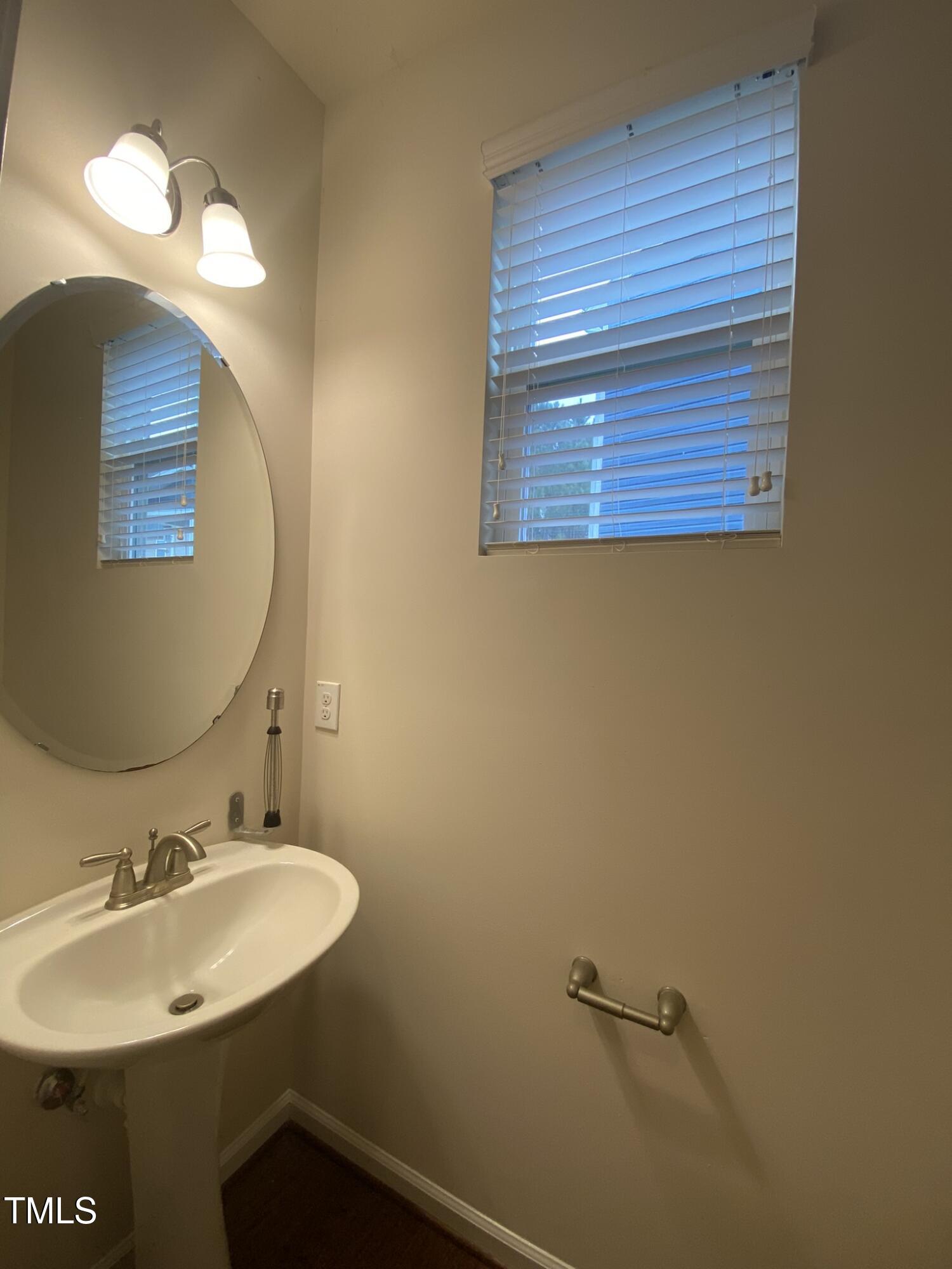 3545 Massey Ridge Court Raleigh, NC 27616 - Photo 13 of 38 a bathroom with a sink and a mirror