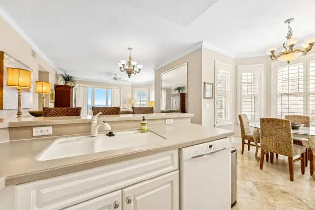 a view of a dining room with furniture and a chandelier