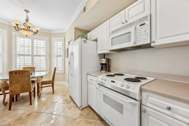 a kitchen with stainless steel appliances granite countertop a stove and a refrigerator