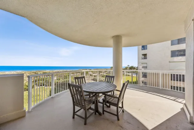 a view of a chairs and table in patio