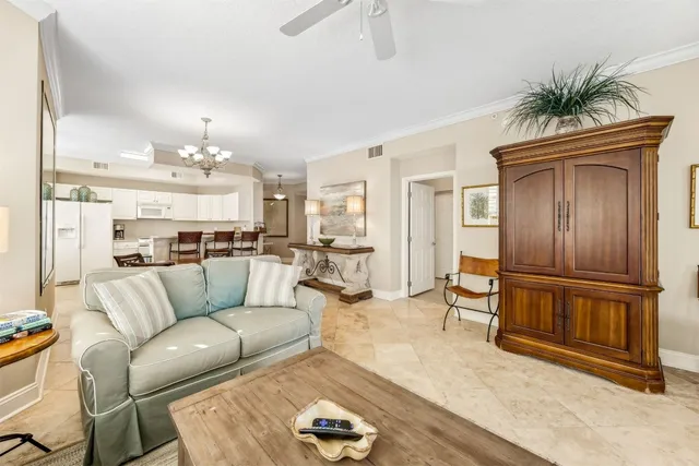 a living room with furniture and a kitchen view