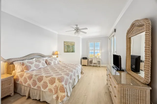 a spacious bedroom with a bed and a flat screen tv