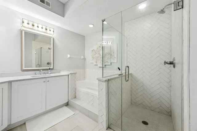 a bathroom with a shower a sink and mirror