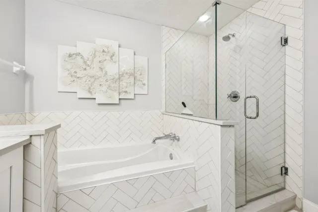 a bathroom with a bathtub and shower