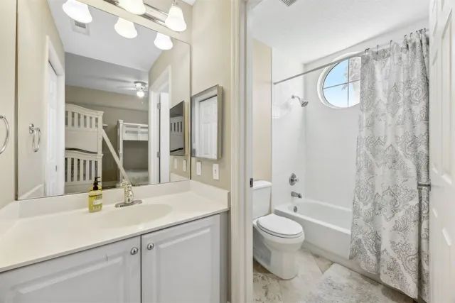 a bathroom with a toilet sink and shower