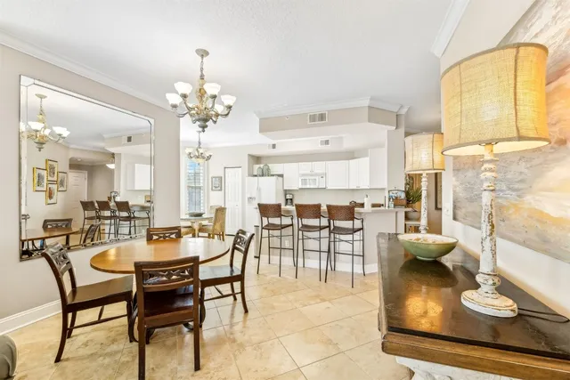 a dining room with furniture and a chandelier