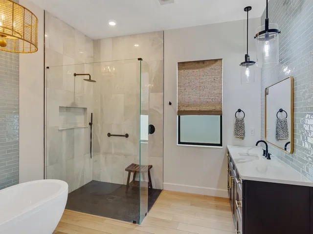 a view of a livingroom with wooden floor and a chandelier