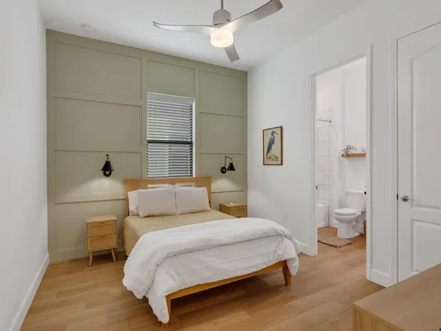 a view of a swimming pool with a yard and palm trees