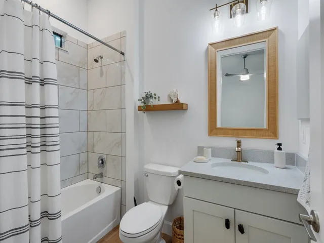 a room with lots of tables a large window and chairs