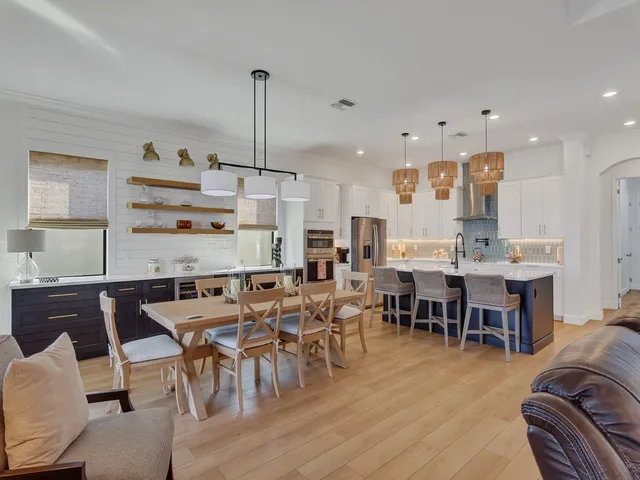 a kitchen with stainless steel appliances granite countertop a sink a oven and a refrigerator
