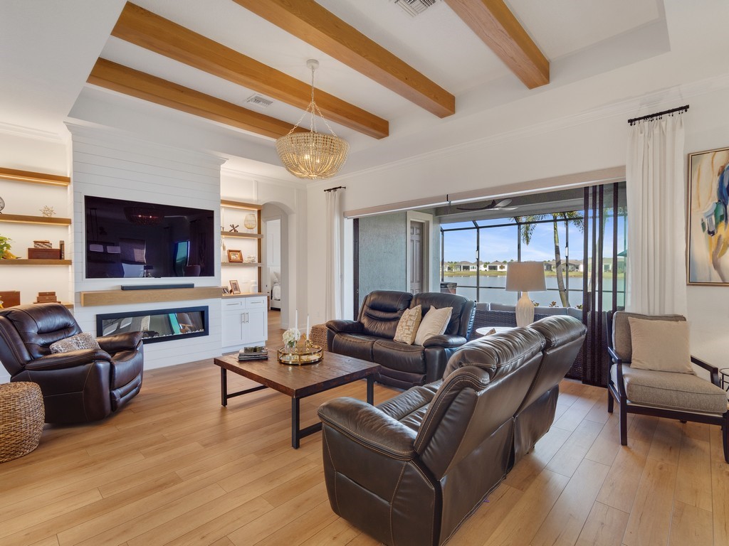 2462 Chapel Bridge Lane Melbourne, FL 32940 - Photo 7 of 36 a living room with furniture and a flat screen tv