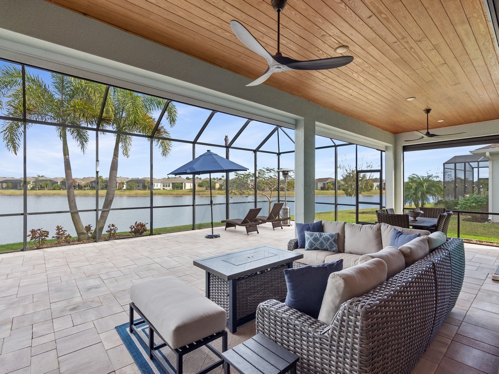 2462 Chapel Bridge Lane Melbourne, FL 32940 - Photo 8 of 36 a living room with furniture and a floor to ceiling window