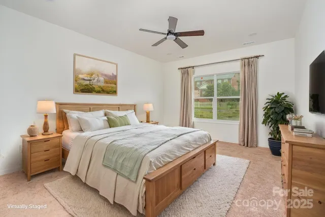 a spacious bedroom with a large bed and a window