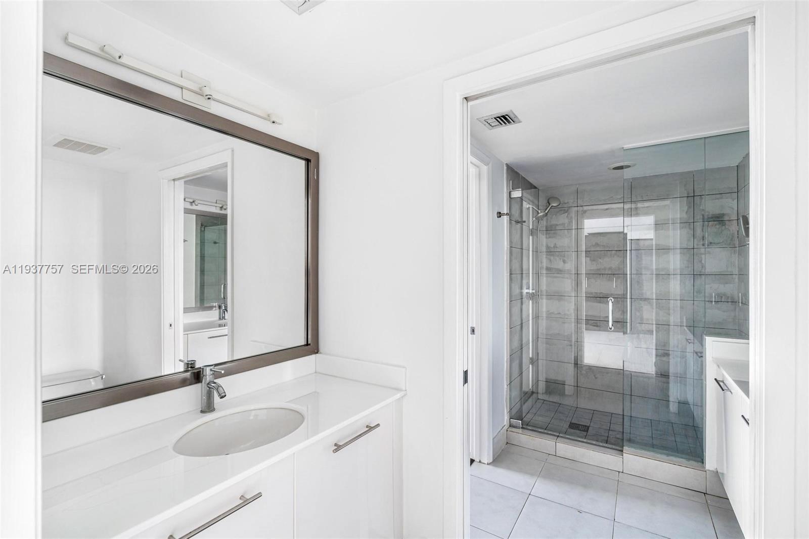 92 Southwest 3rd Street, Unit 4109 Miami, FL 33130 - Photo 7 of 23 a bathroom with a sink and a mirror