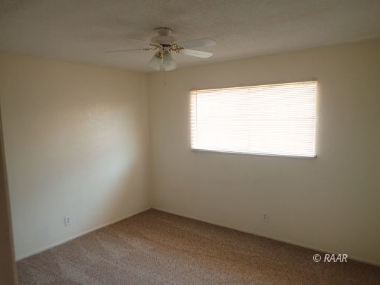 1144 West Boston Avenue Ridgecrest, CA 93555 - Photo 7 of 13 an empty room with a window