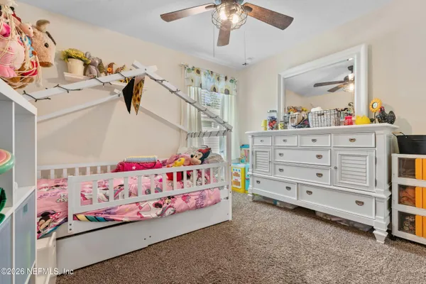 a bedroom with a bed and a white cabinet