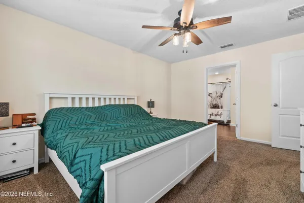 a living room with a bed and a chandelier