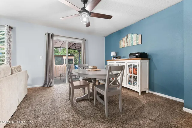a view of a dining room with furniture window and outside view