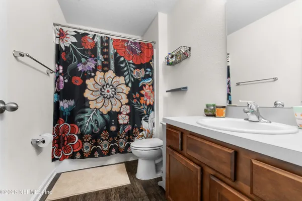 a view of a bathroom with a sink and wooden floor