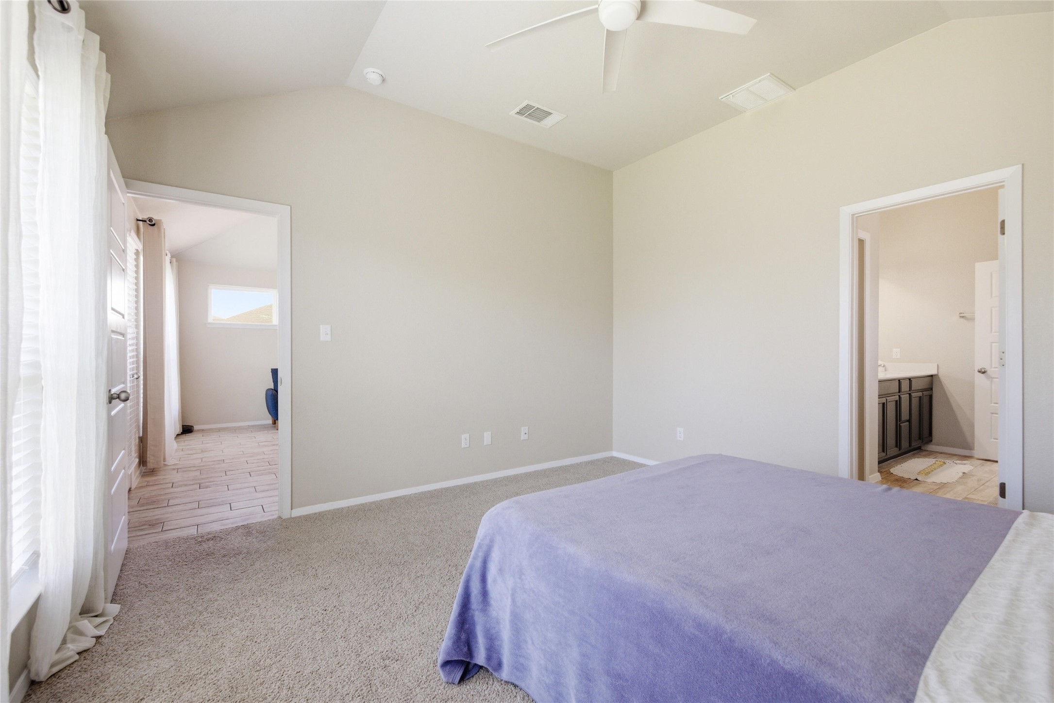269 Gaida Loop Georgetown, TX 78628 - Photo 11 of 20 Bedroom with a ceiling fan, light colored carpet, and ensuite bath