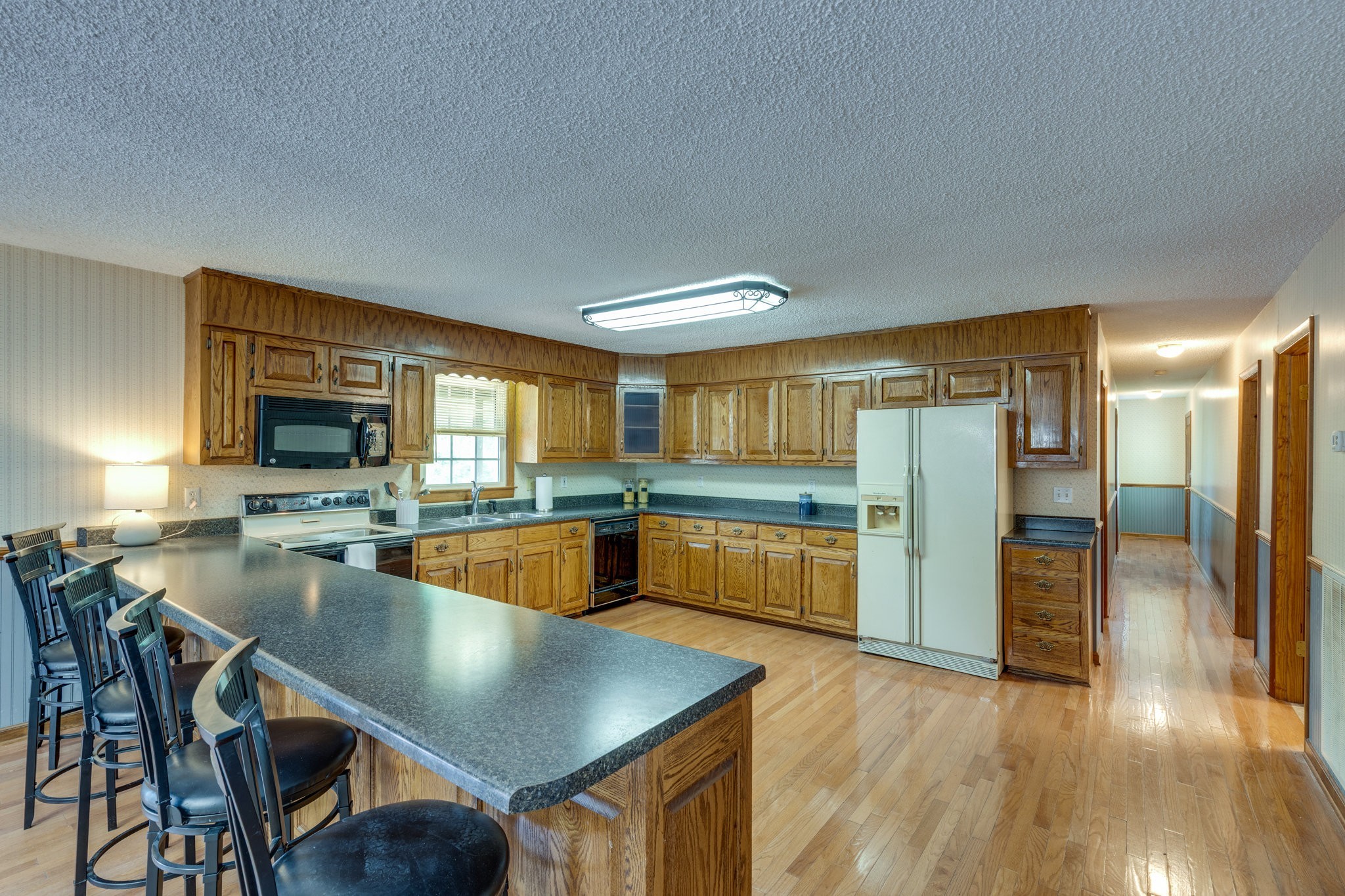 1087 Charley Davis Road Goodspring, TN 38460 - Photo 17 of 80 a kitchen with stainless steel appliances granite countertop a sink a stove and a refrigerator
