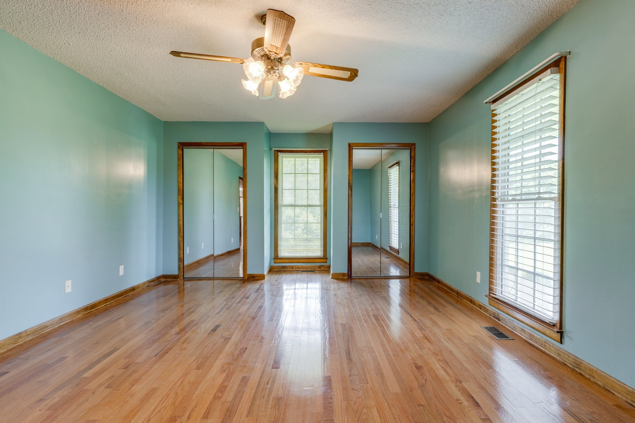 1087 Charley Davis Road Goodspring, TN 38460 - Photo 19 of 80 an empty room with wooden floor fan and windows
