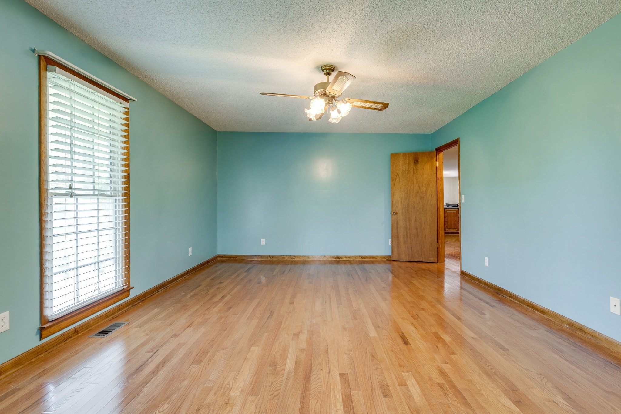1087 Charley Davis Road Goodspring, TN 38460 - Photo 21 of 80 a view of an empty room with wooden floor and a window