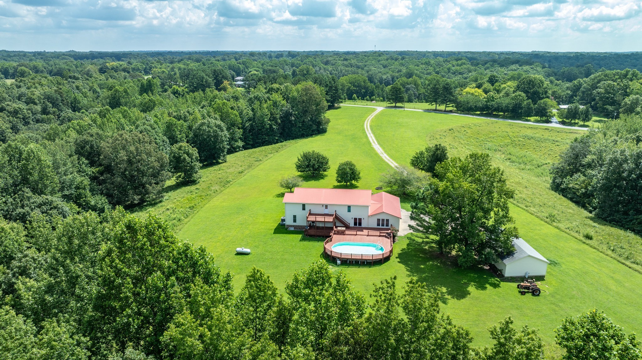 1087 Charley Davis Road Goodspring, TN 38460 - Photo 47 of 80 an aerial view of a house with a swimming pool a yard and green space