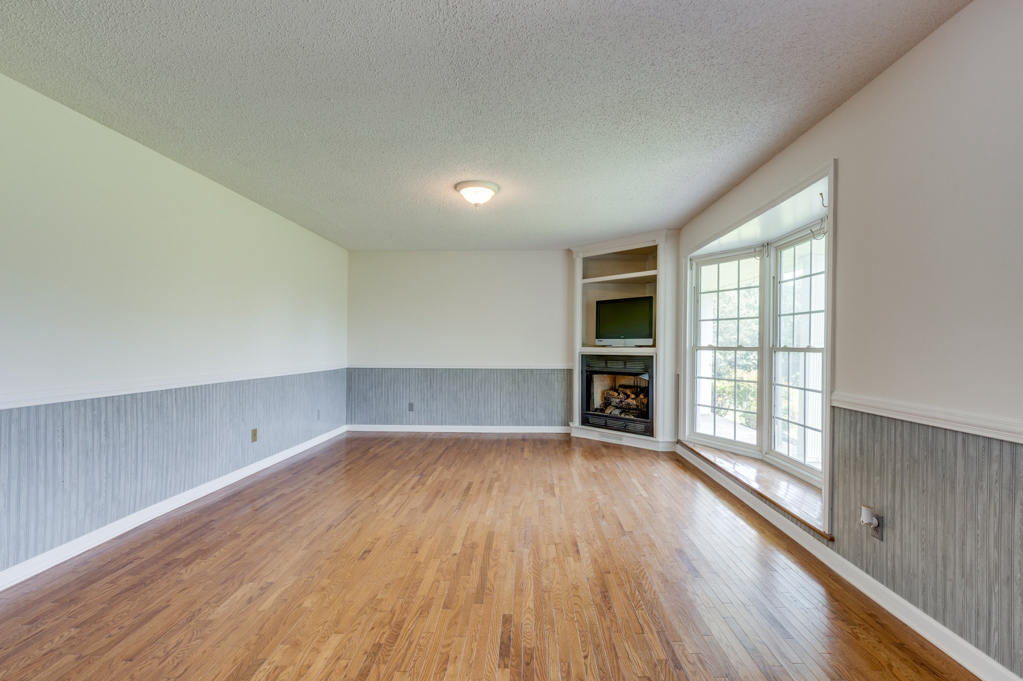 1087 Charley Davis Road Goodspring, TN 38460 - Photo 6 of 80 wooden floor in an empty room with a window