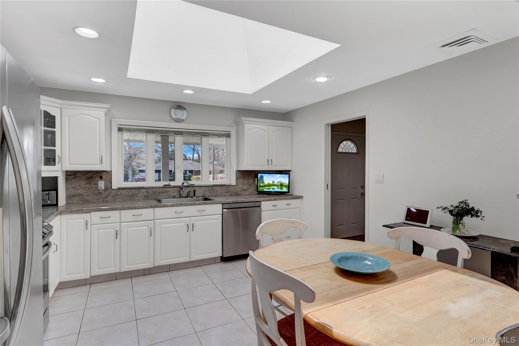 27 Cedar Street Syosset, NY 11791 - Photo 13 of 28 a kitchen with sink and refrigerator