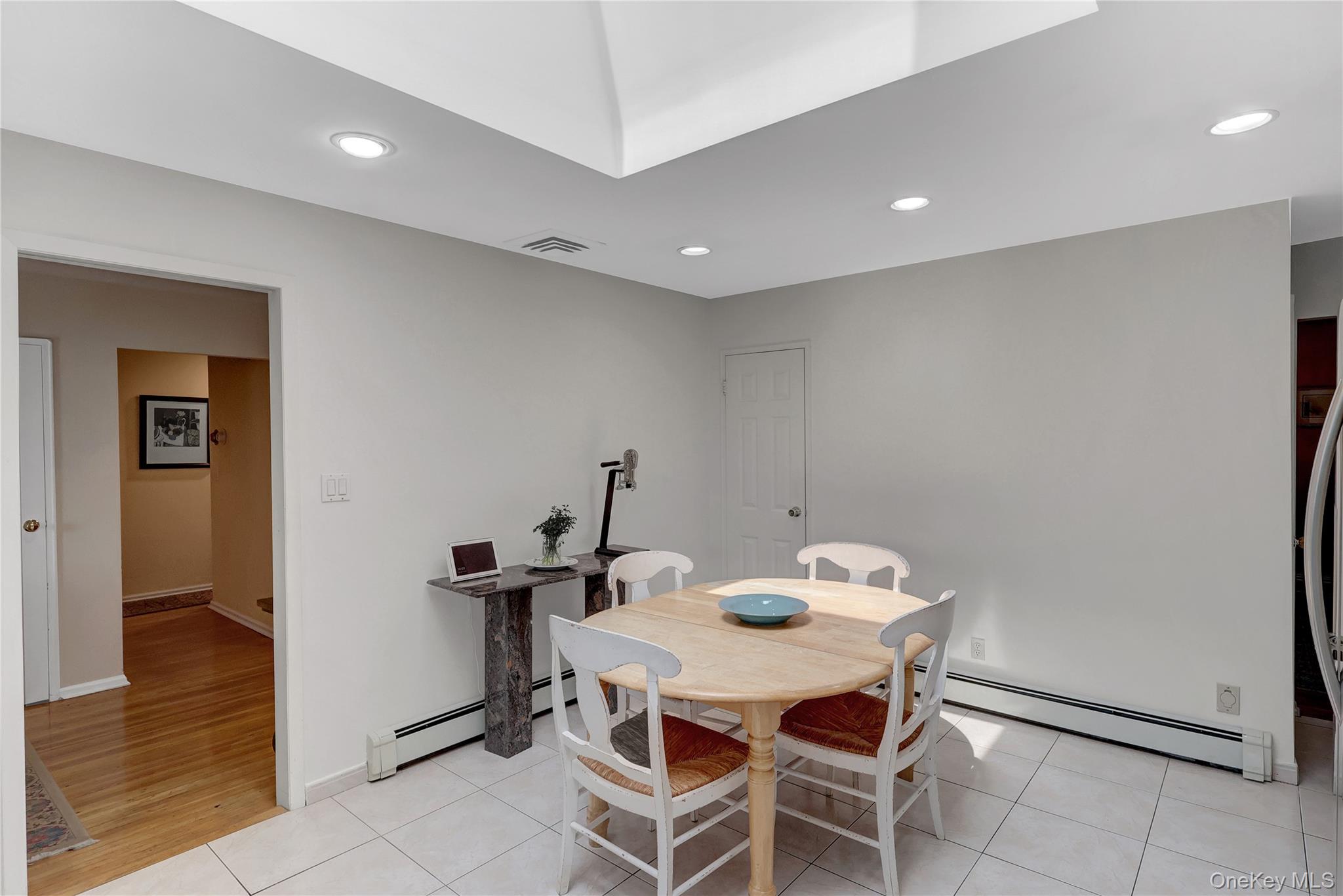 27 Cedar Street Syosset, NY 11791 - Photo 14 of 28 a dining room with furniture and wooden floor