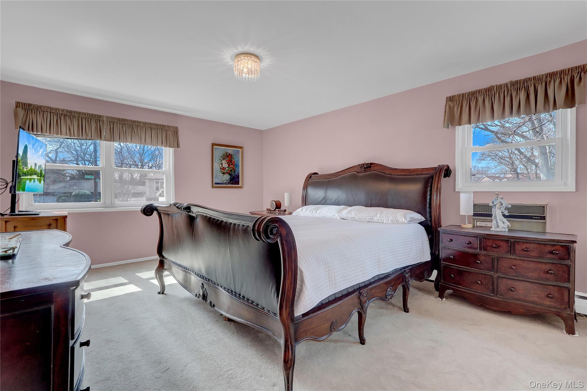 27 Cedar Street Syosset, NY 11791 - Photo 15 of 28 a bedroom with a bed and a window