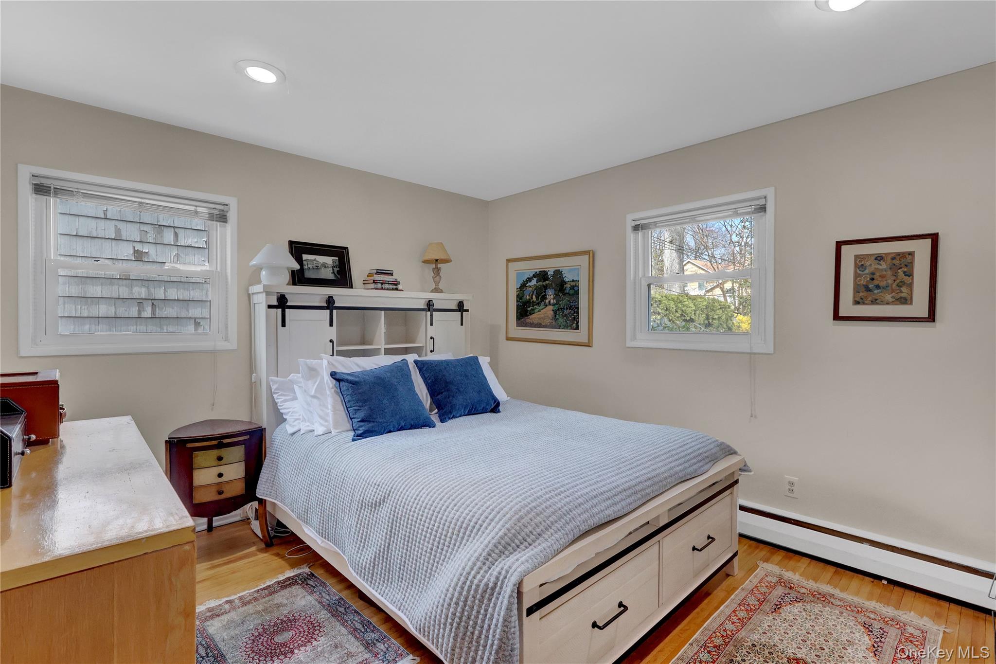 27 Cedar Street Syosset, NY 11791 - Photo 17 of 28 a bedroom with a bed and a window