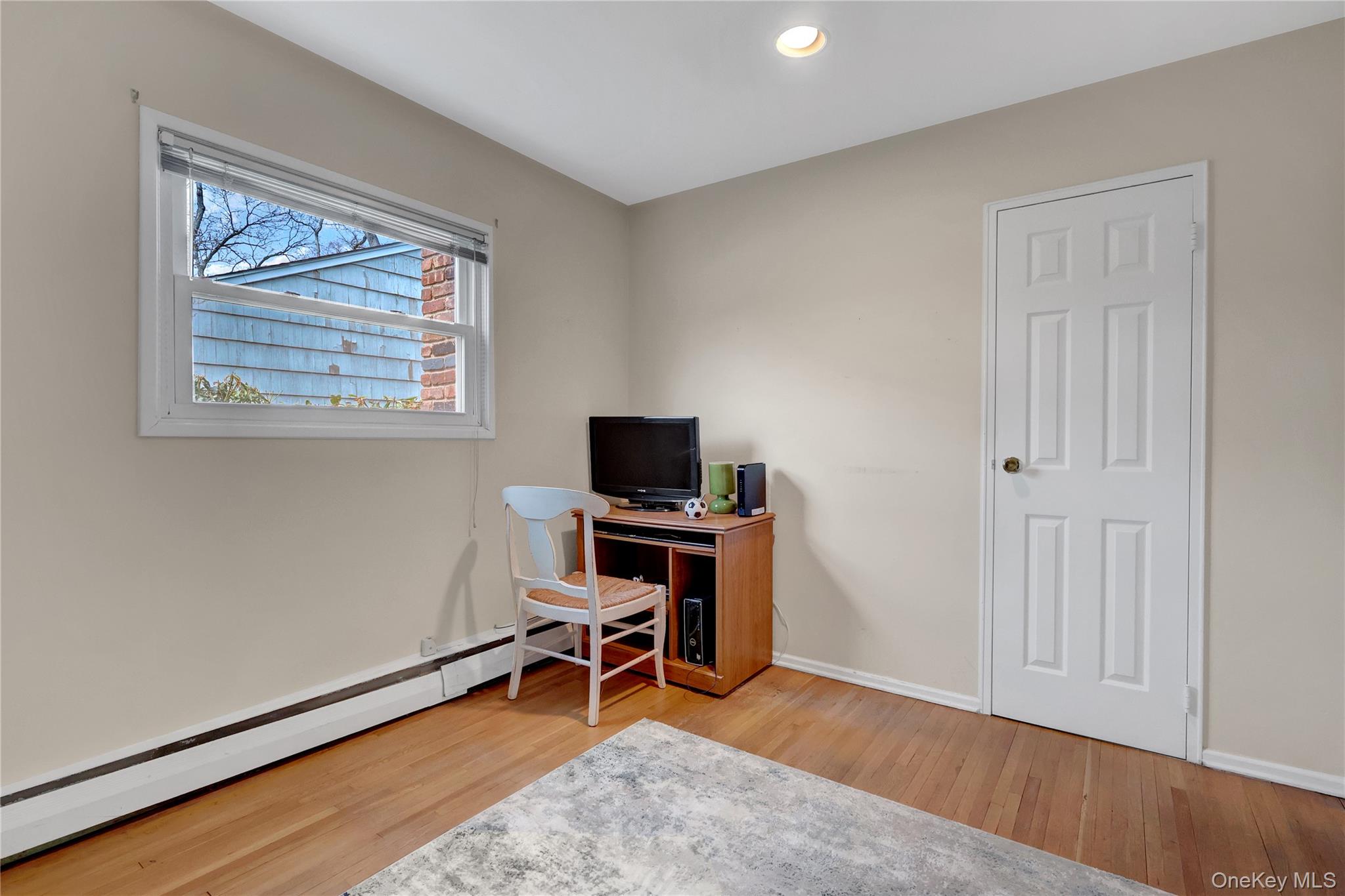 27 Cedar Street Syosset, NY 11791 - Photo 19 of 28 a view of a workspace with furniture and a window