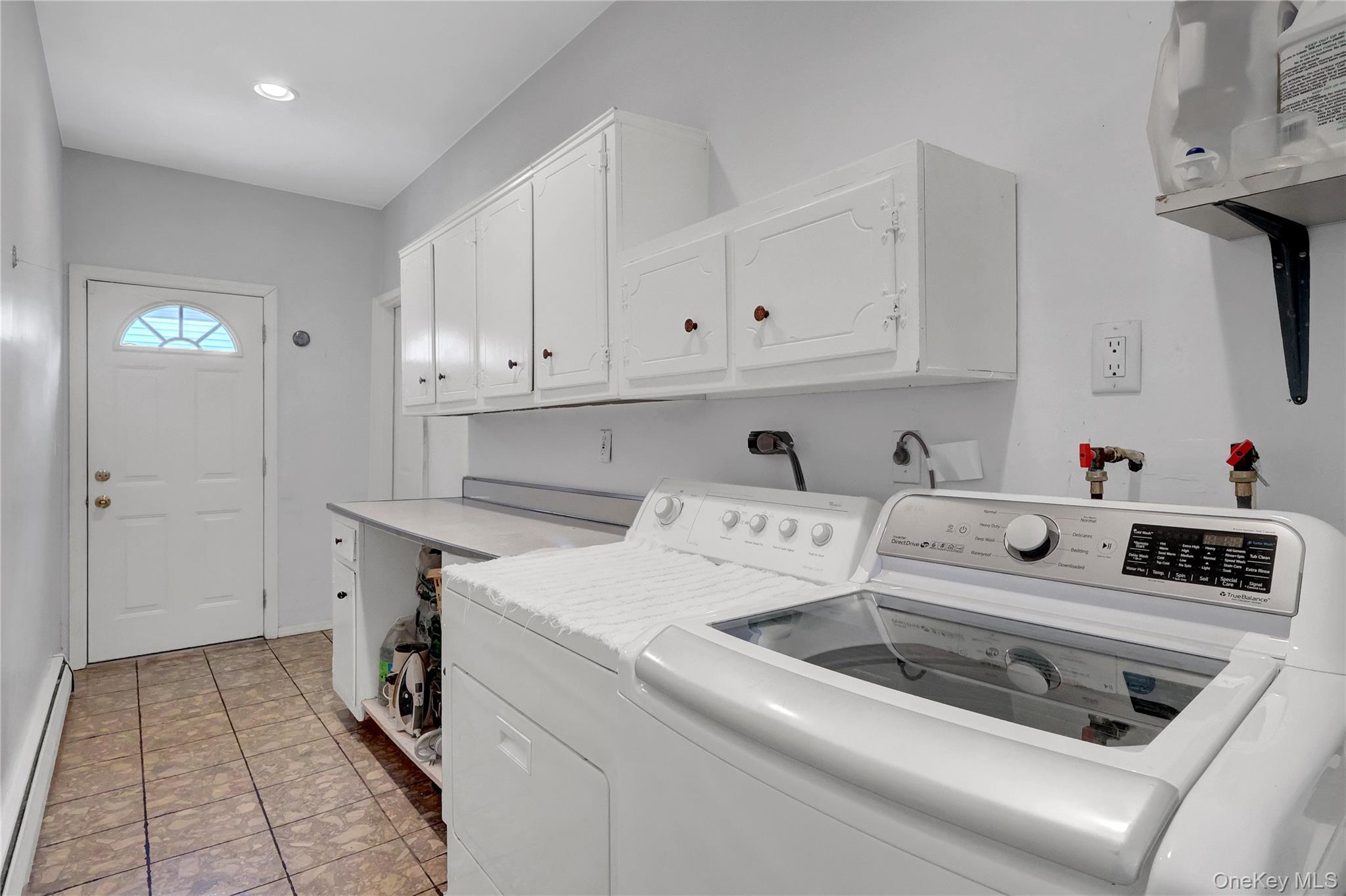 27 Cedar Street Syosset, NY 11791 - Photo 20 of 28 a utility room with dryer and washer