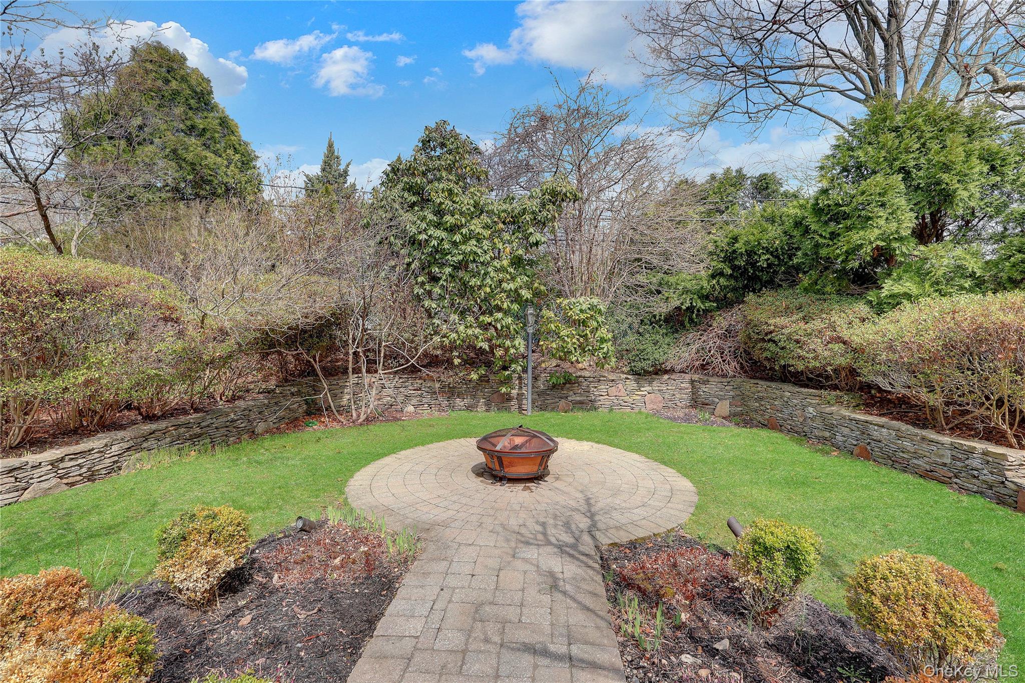 27 Cedar Street Syosset, NY 11791 - Photo 23 of 28 a view of a garden with potted plants