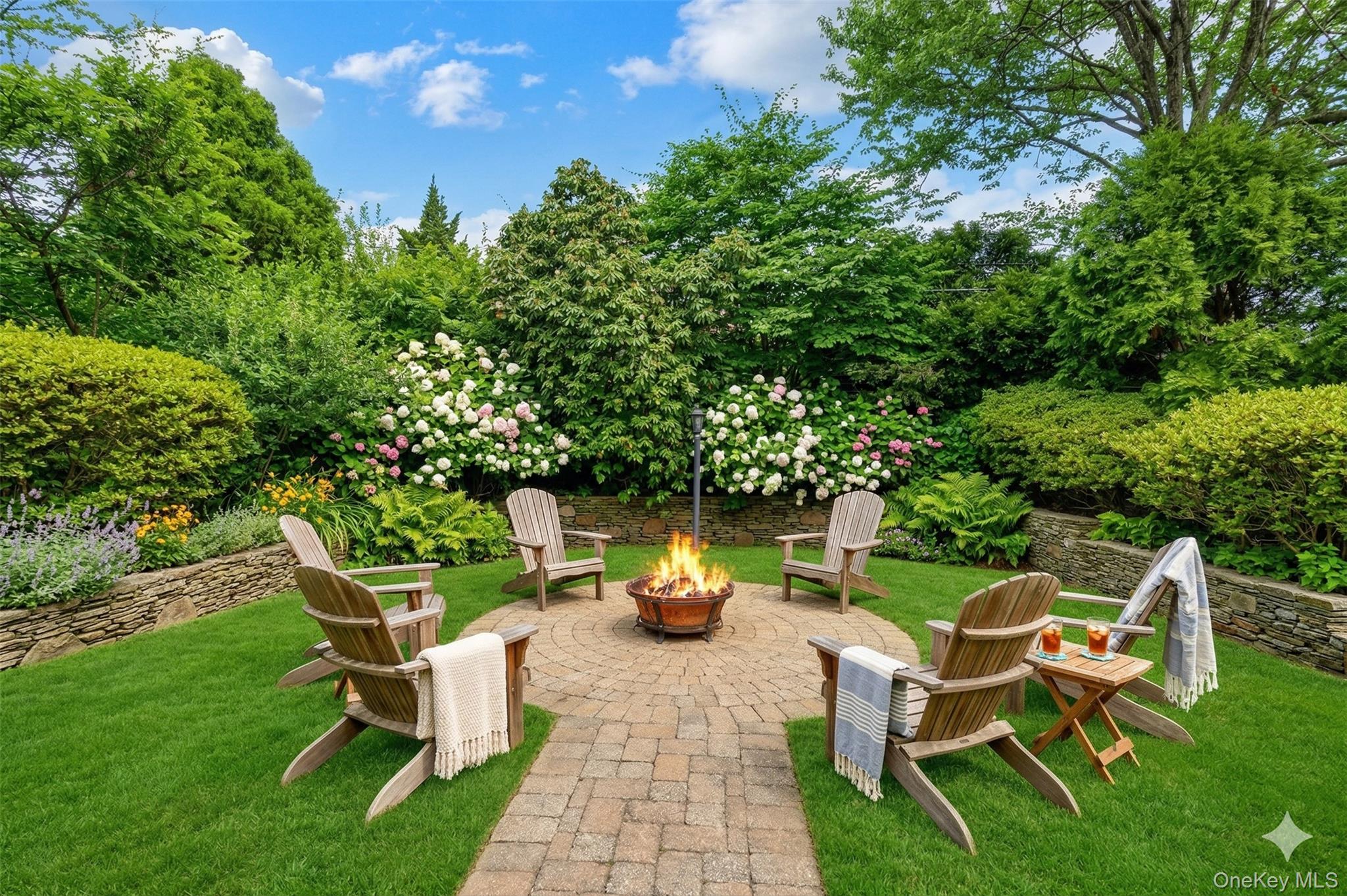 27 Cedar Street Syosset, NY 11791 - Photo 24 of 28 a view of a wooden chairs and table in the back yard