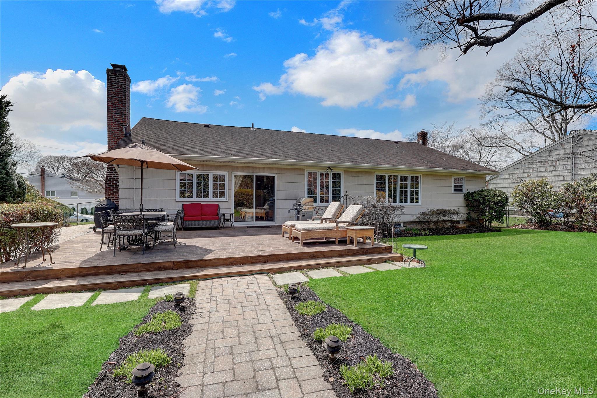 27 Cedar Street Syosset, NY 11791 - Photo 25 of 28 a front view of a house with swimming pool garden and patio