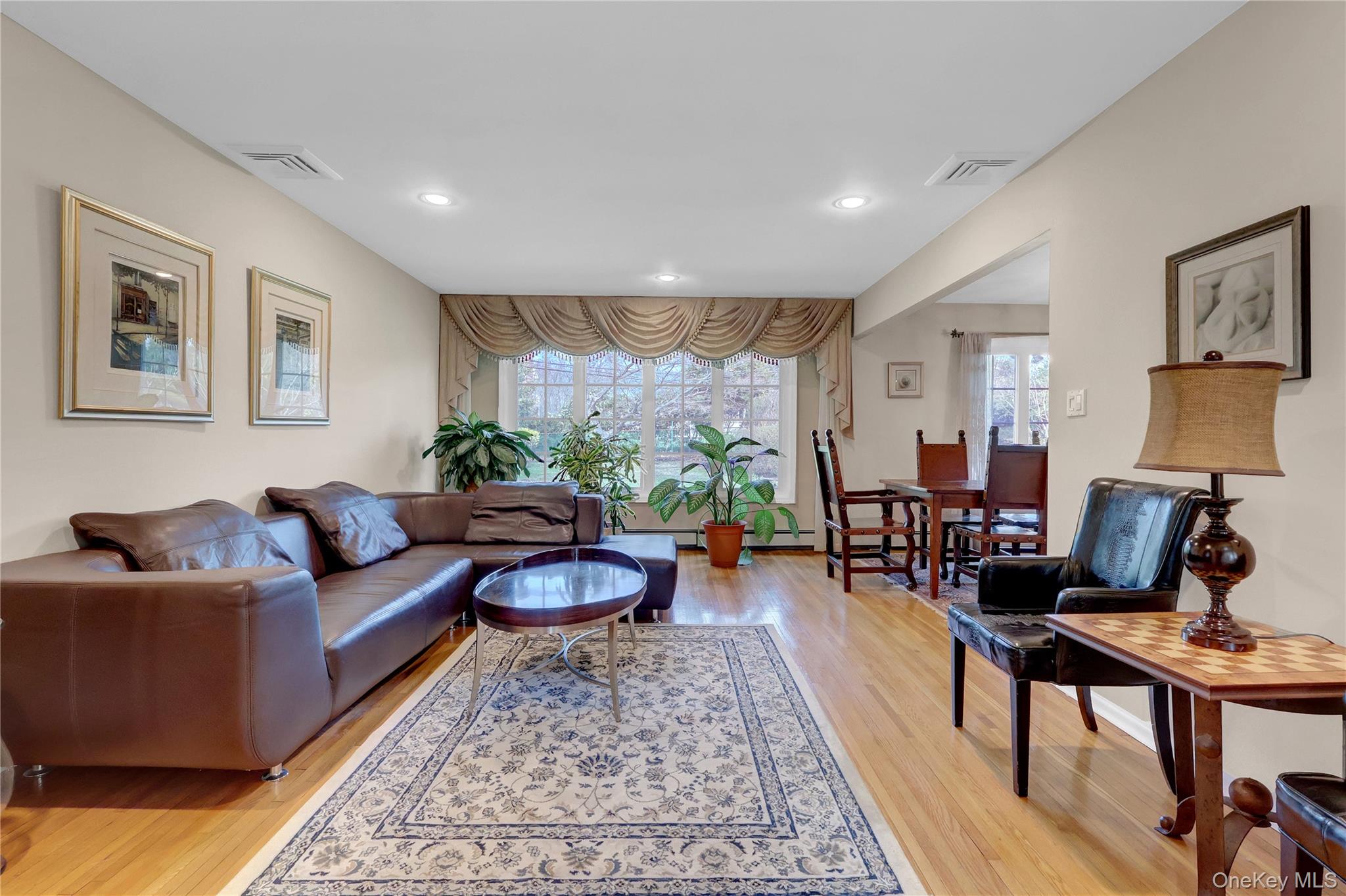27 Cedar Street Syosset, NY 11791 - Photo 5 of 28 a living room with furniture and a large window