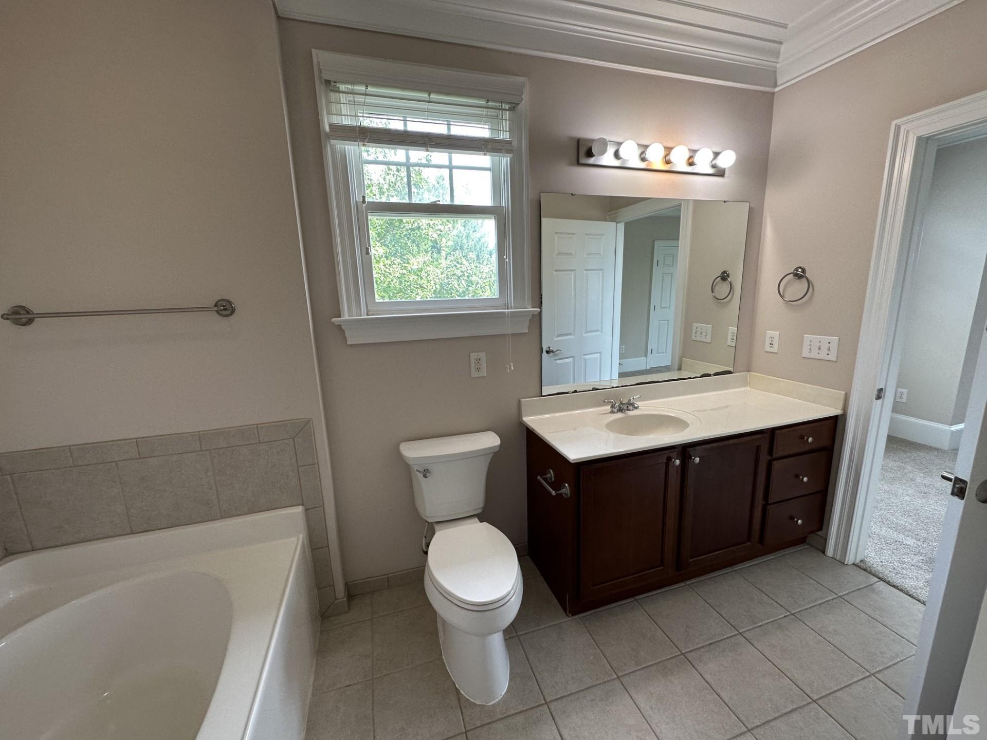 623 Waterford Lake Drive, Unit 623 Cary, NC 27519 - Photo 16 of 18 a bathroom with a sink vanity granite toilet and a bathtub