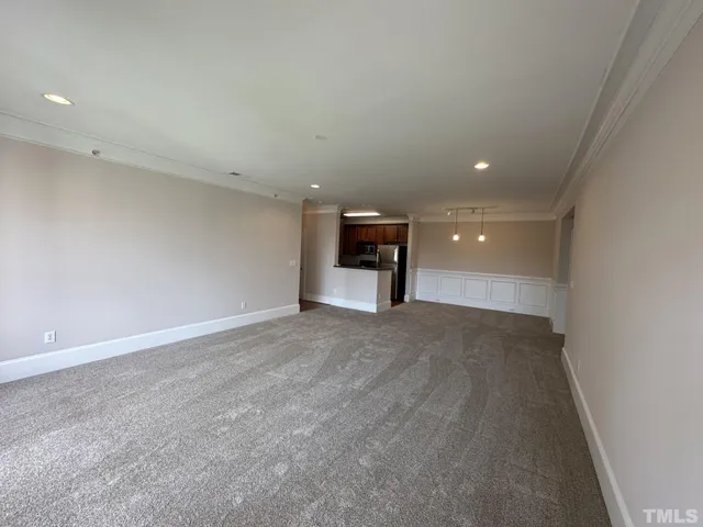 a kitchen with kitchen island a counter top space cabinets and refrigerator