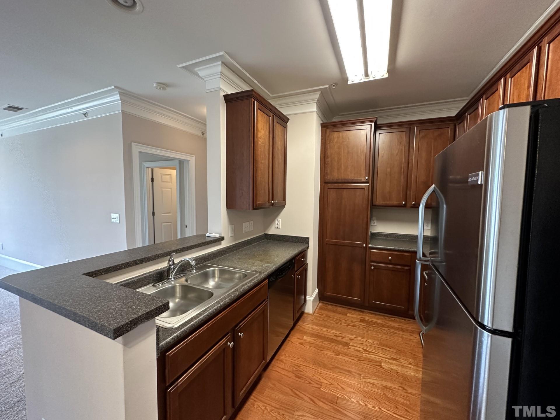 623 Waterford Lake Drive, Unit 623 Cary, NC 27519 - Photo 7 of 18 a kitchen with granite countertop a refrigerator and a sink