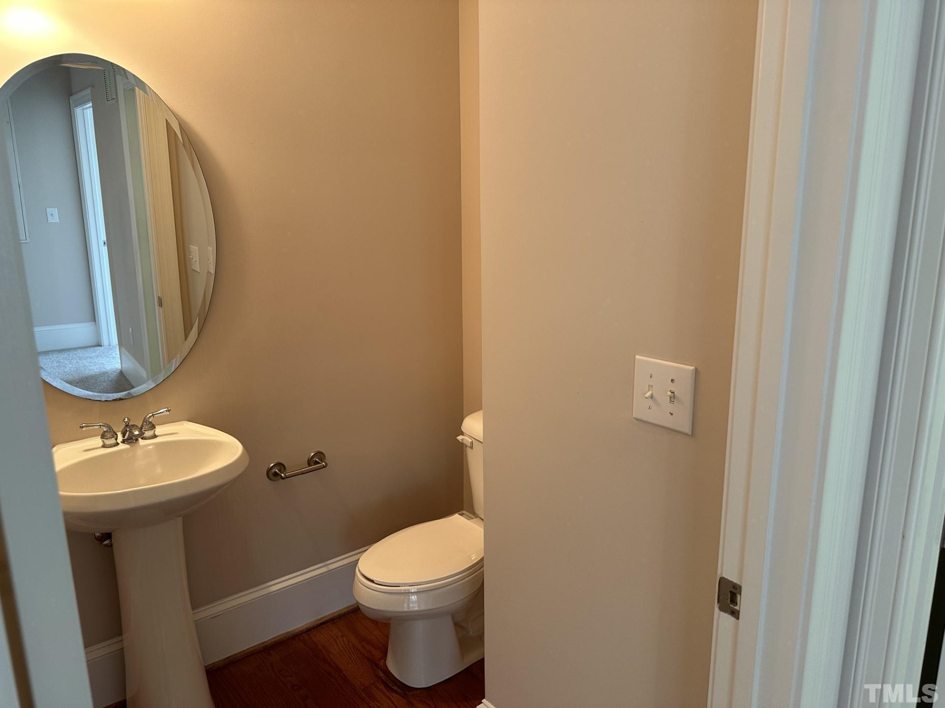 623 Waterford Lake Drive, Unit 623 Cary, NC 27519 - Photo 10 of 18 a bathroom with a toilet a sink and a mirror