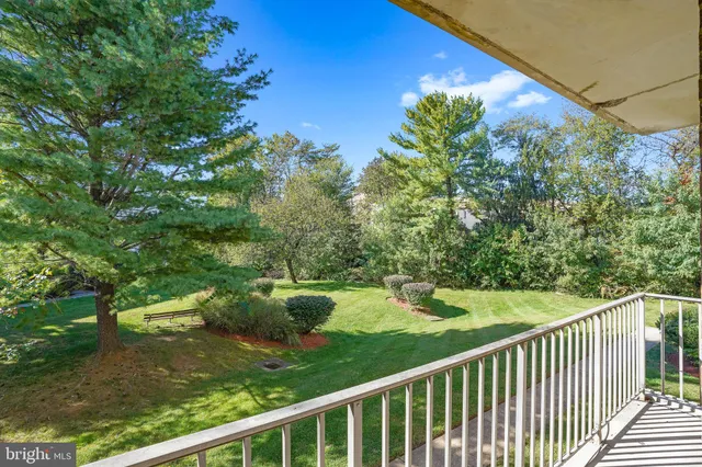 a view of a balcony with yard