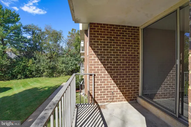 a view of balcony with wooden floor and fence