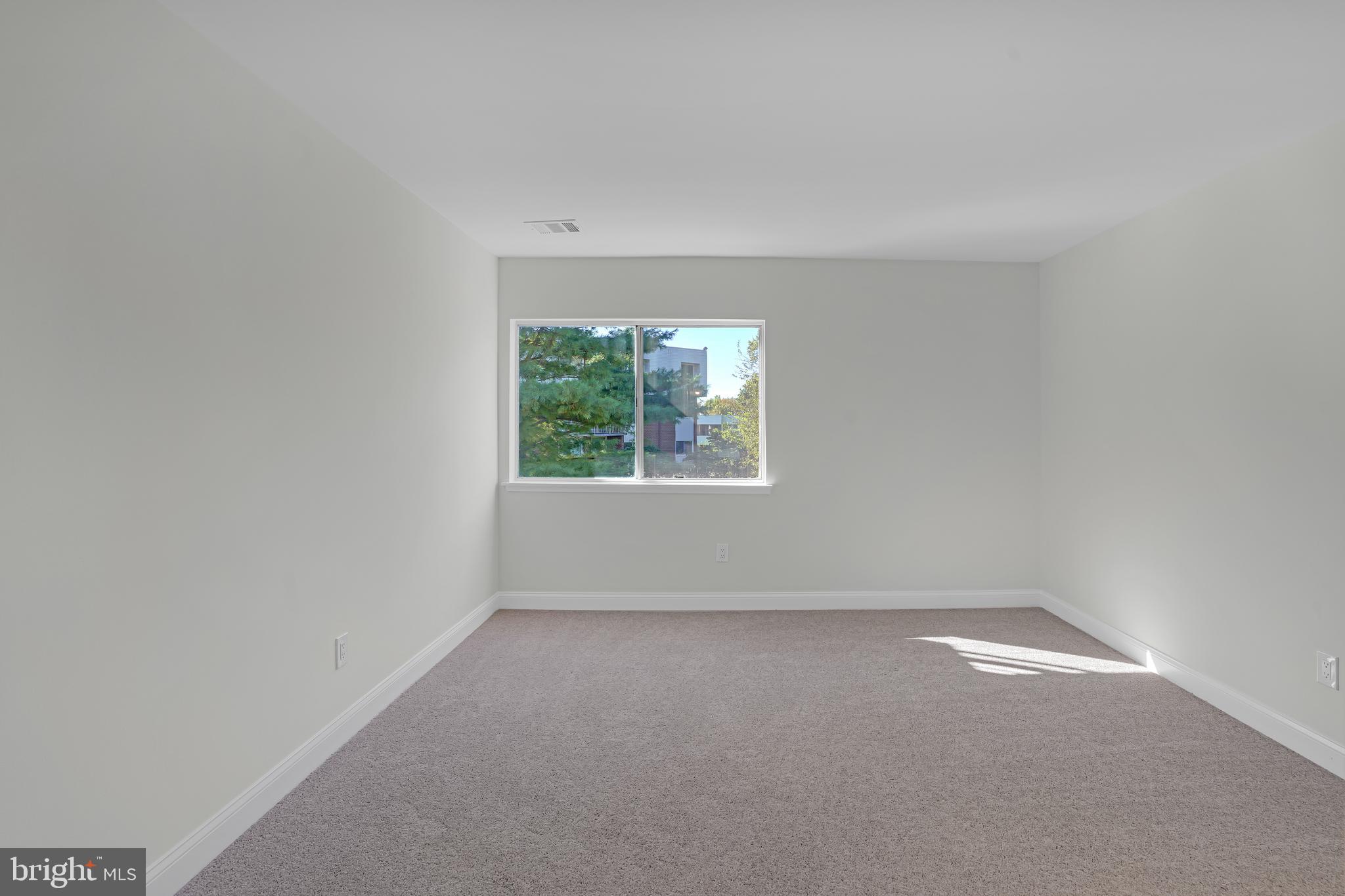 10239 Prince Place, Unit 26103 Upper Marlboro, MD 20774 - Photo 17 of 25 an empty room with a window
